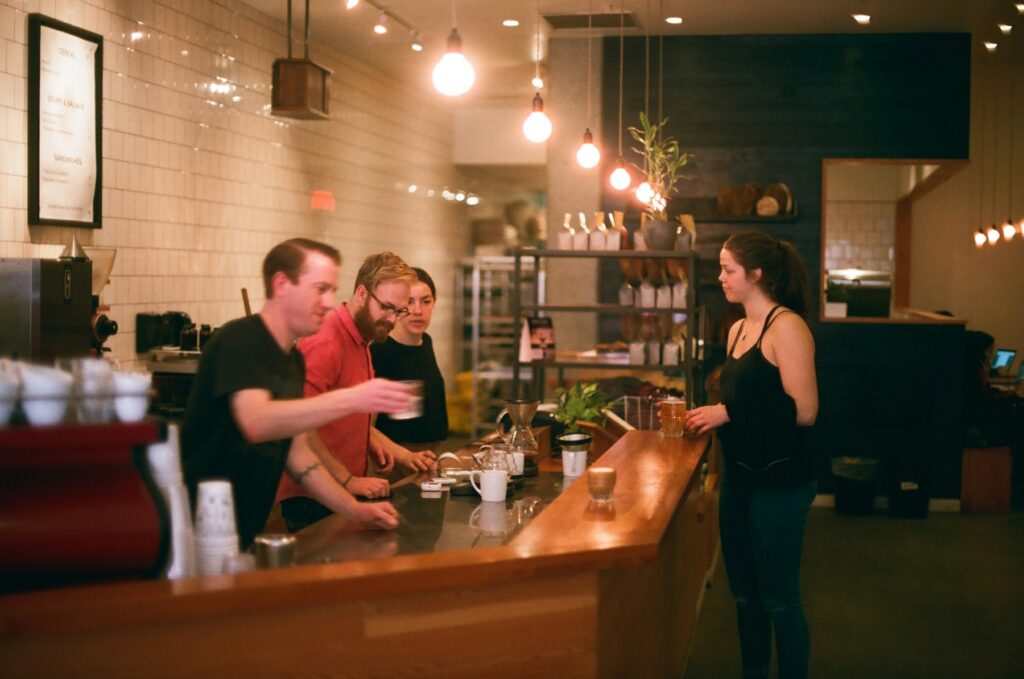 Customers ordering at a coffee shop counter