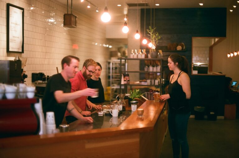 Customers ordering at a coffee shop counter